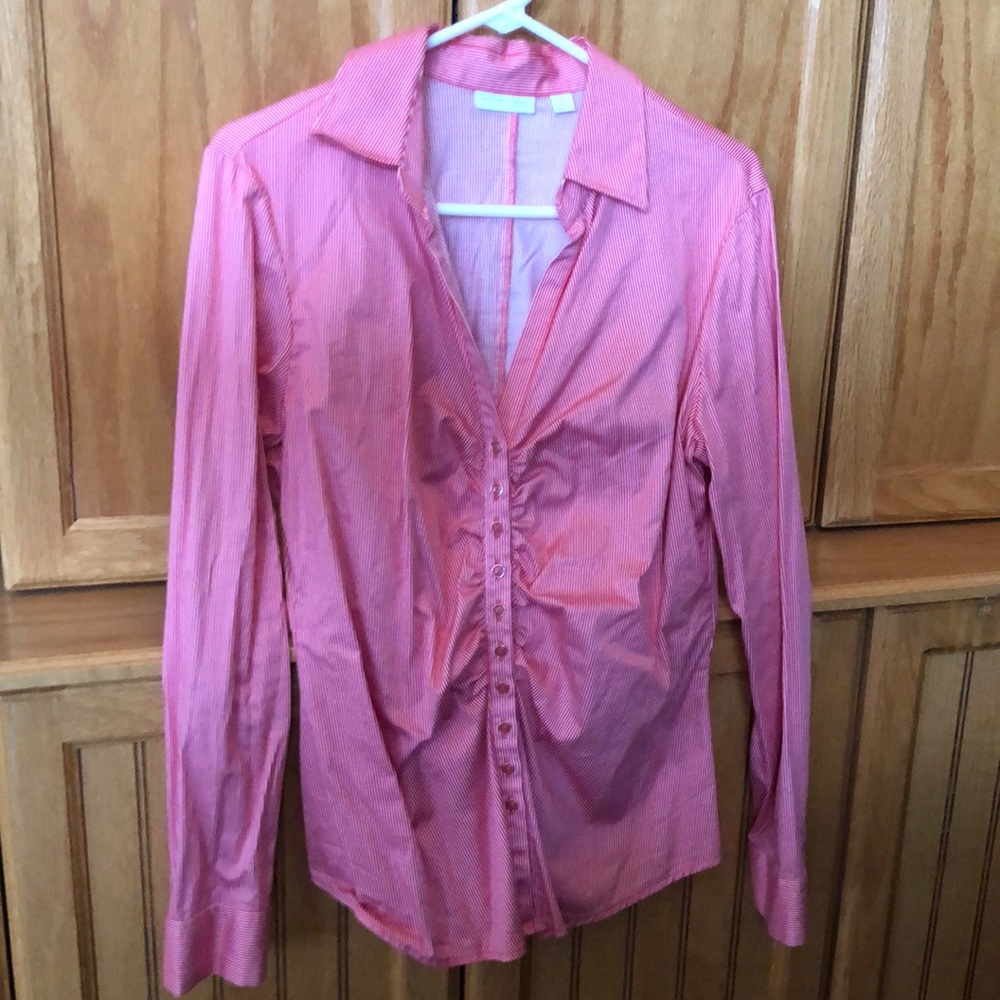 Buttons down, red and white striped shirt.